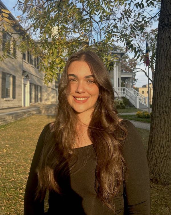 photo of student in front of trees