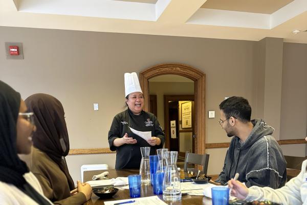 Chef speaking to students at a menu tasting
