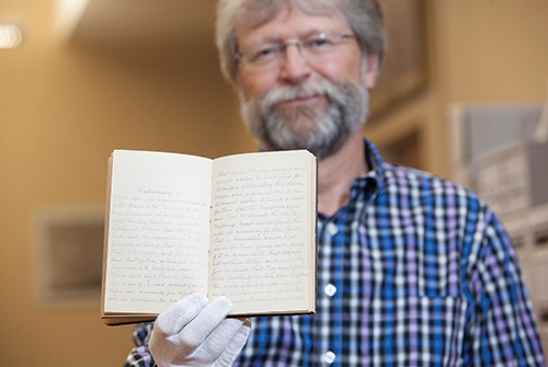 Queen's Archivist Paul Banfield with the MacMartin diary