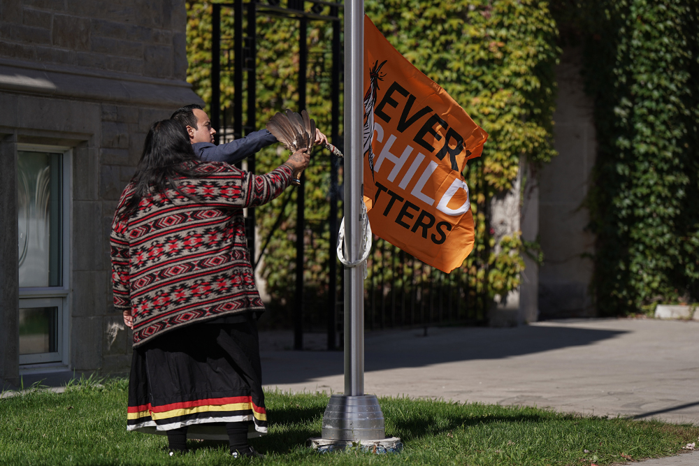 Every Child Matter flag being raised outside Richardson Hall