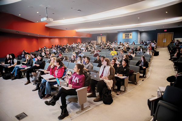 Students attending class in an auditorium.
