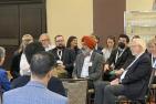 An audience listens to a panel presentation.