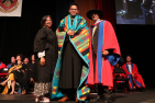 Indigenous graduate receiving Blackfoot Peoples Mountain Blanket