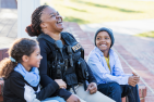 A police officer laughs with her children