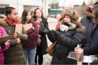 A teacher speaks to a group of students