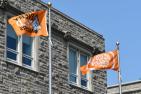 The Survivors' Flag (right) flying alongside the Every Child Matters flag outside Richardson Hall on the Queen's Campus.