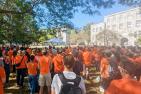 People wearing orange shirts attend the sacred fire at Queen's University