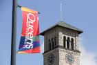 A Queen's banner flies in front of Grant Hall.