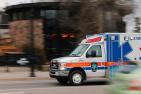 An ambulance drives along a busy street.