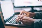 Photo of hands typing on laptop