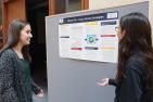 students talking about a research poster