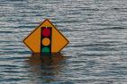 [Traffic sign in flood waters]