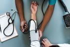Doctor checking a patient's blood pressure (Credit: Raw Pixel, from Unsplash)