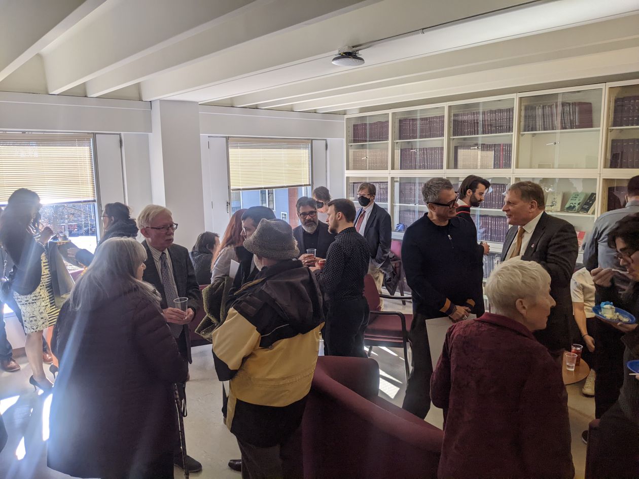 A group of students and faculty in the Watson Hall Lounge 