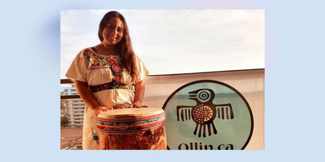Photo of Yessica Rivera Belsham infront of a drum.