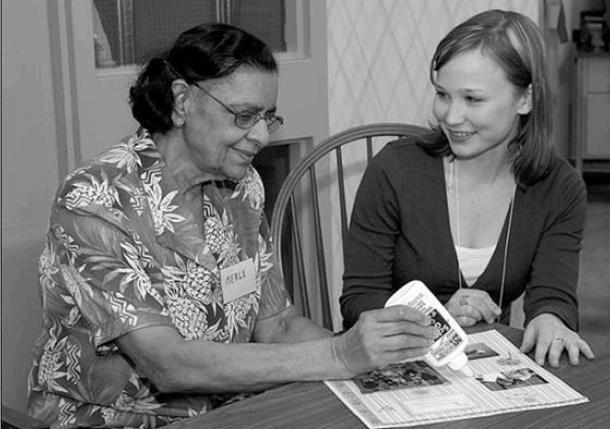 Cassandra Brown, Research Assistant (right), with Merle Domingo at the Alzheimer Society offices in the Rideaucrest Home. (Courtesy of the Kingston Whig-Standard, 21 March 2009)