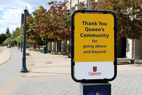 Billboard on campus thanking the Queen's community.