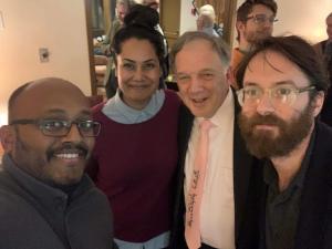 Four people smiling for a photo