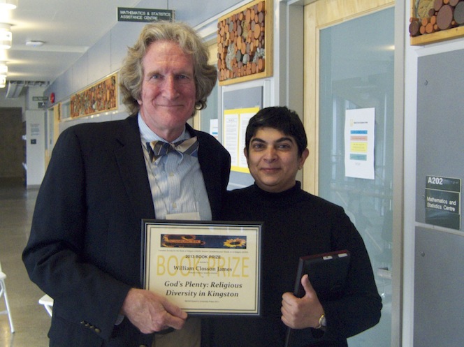 Professor Emeritus William Closson James holding receiving an award