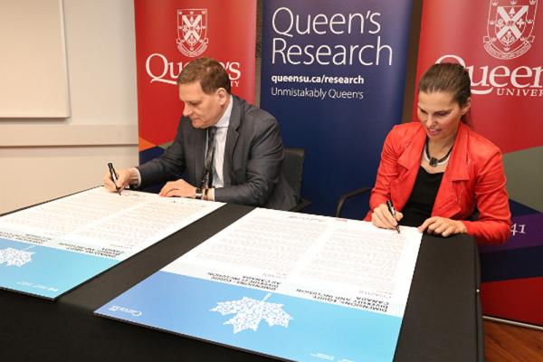 [Queen's Principal and Vice-Chancellor, Daniel Woolf, and Minister of Science and Sport, Kirsty Duncan, sign the Dimensions EDI charter.]