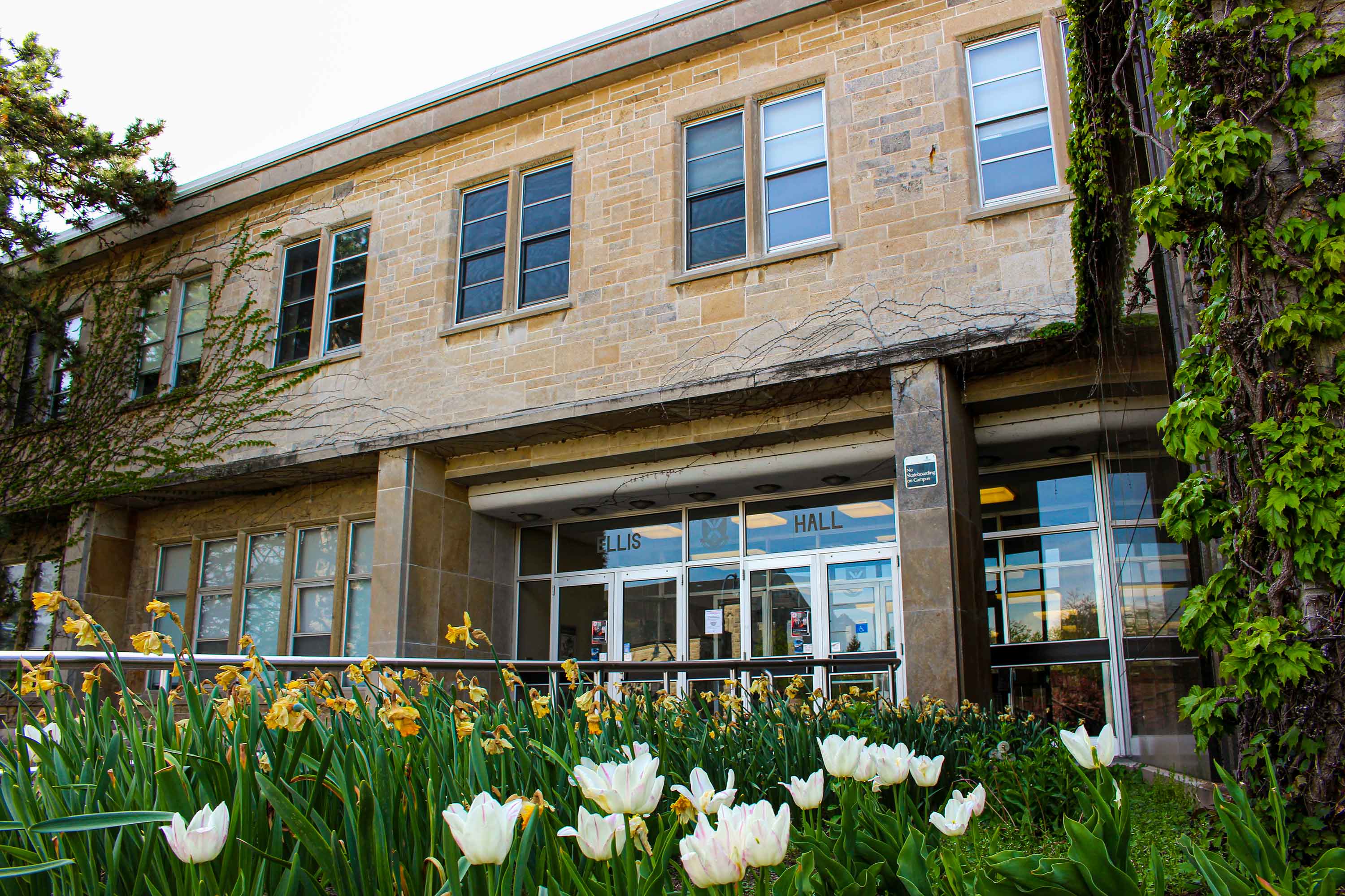 outside of Ellis Hall with flower garden in front