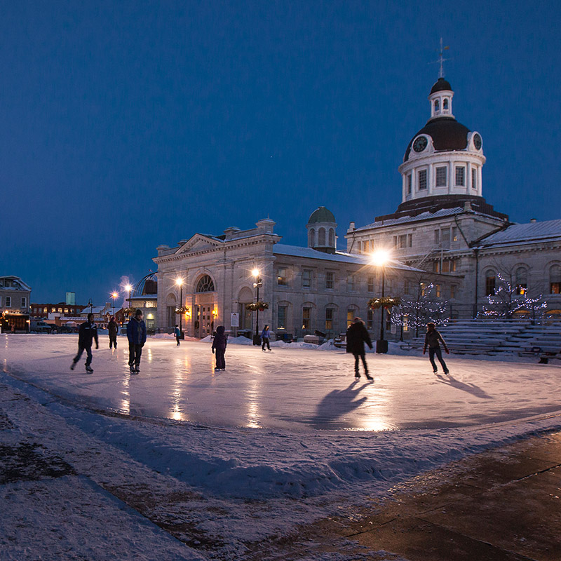 People skating on an ice rink in the market square next to Kingston's city hall