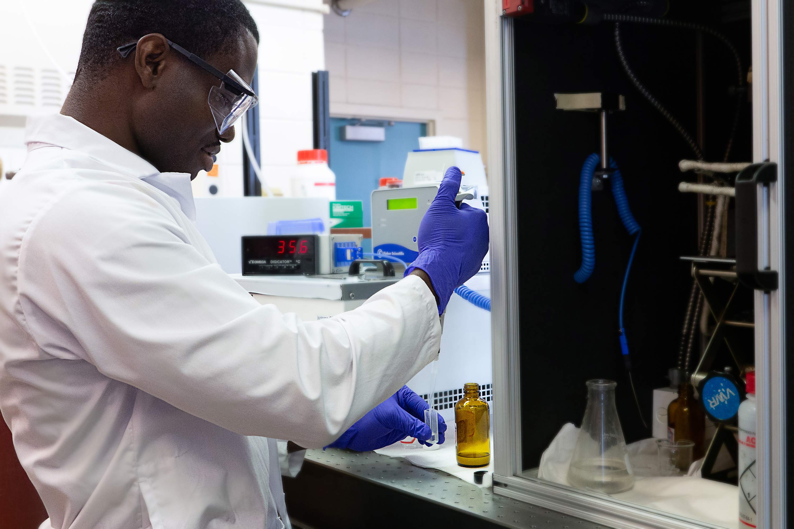 Student in chemical engineering lab using dropper to put sample in test tube