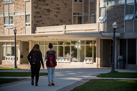 Two students walking together on campus